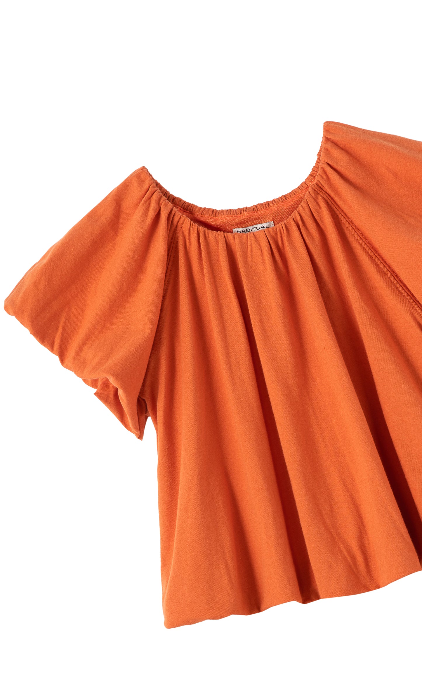 Close up view of an orange off the shoulder top