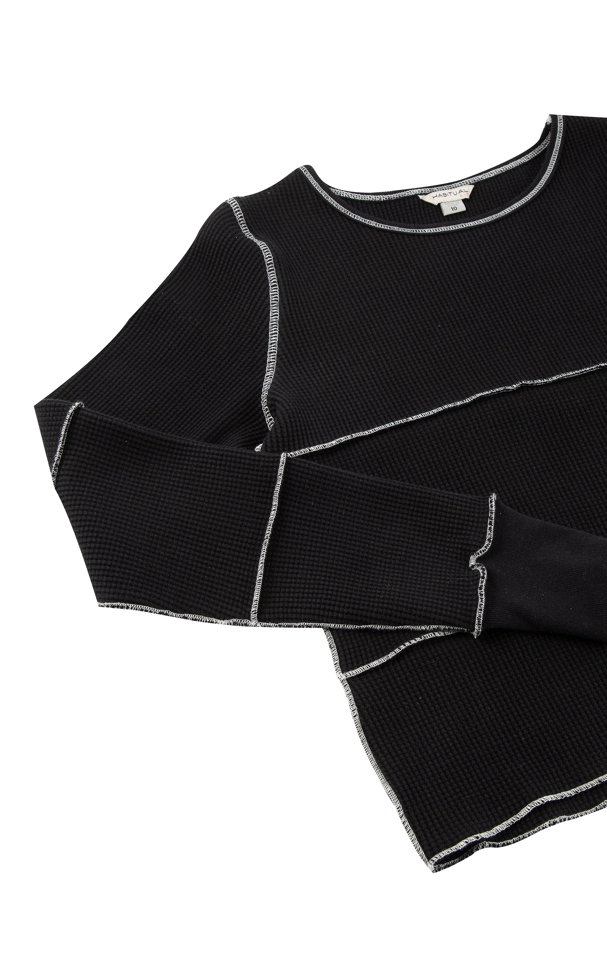 Close up view of black long sleeve with white stitching 