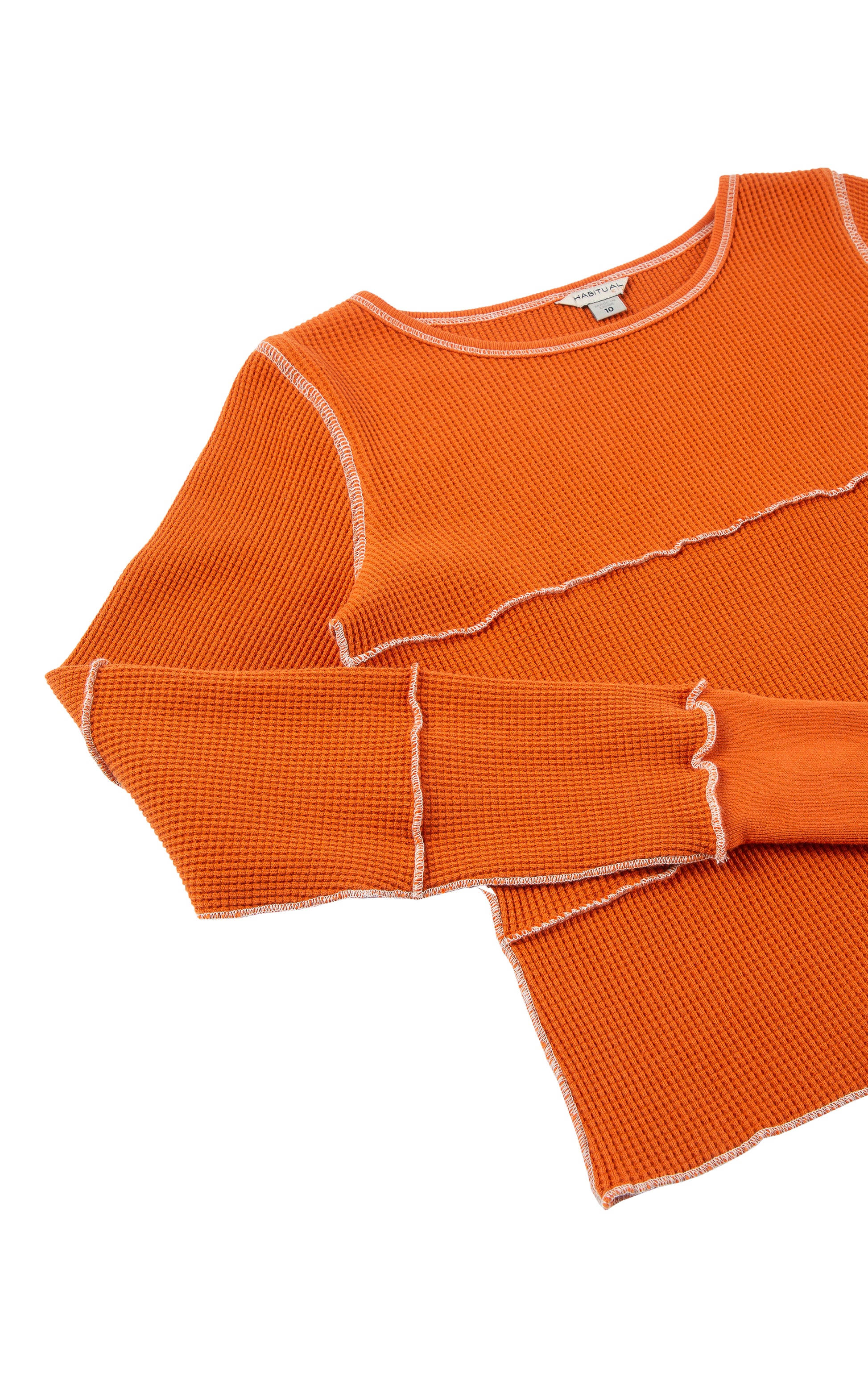 Close up view of orange long sleeve with white stitching 