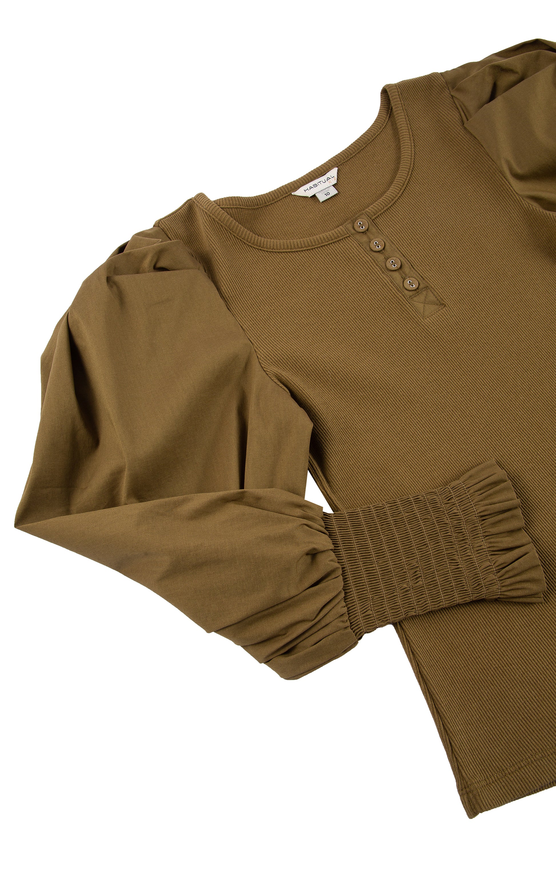 CLOSE UP OF BROWN LONG-SLEEVE TOP WITH FOUR BUTTONS AT THE COLLAR, PUFFY SLEEVES, AND SMOCKED CUFFS