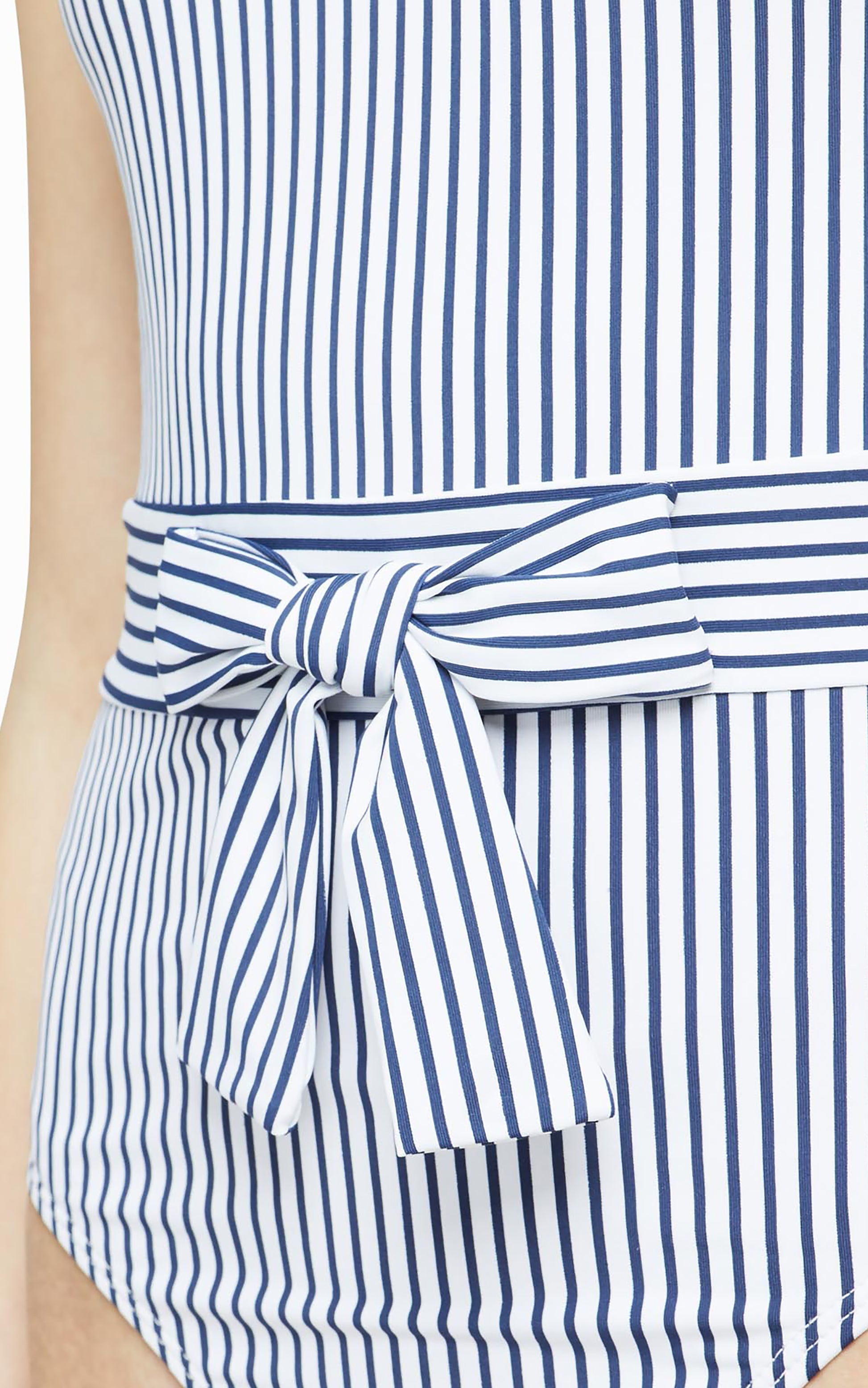 Close up of tie at waist on white and blue-striped swimsuit.