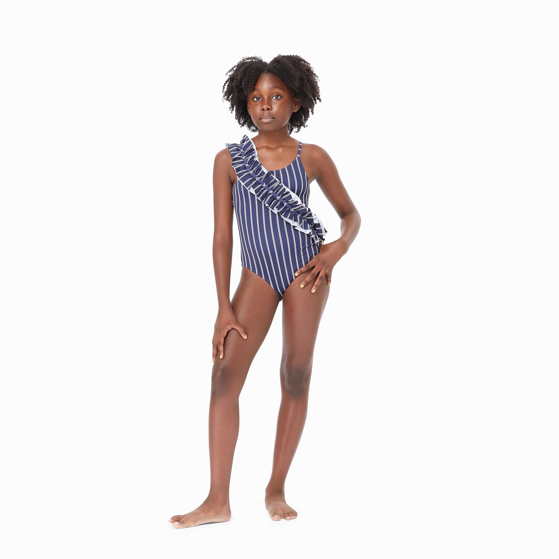 Girl wearing navy ruched one-piece swimsuit with white stripes