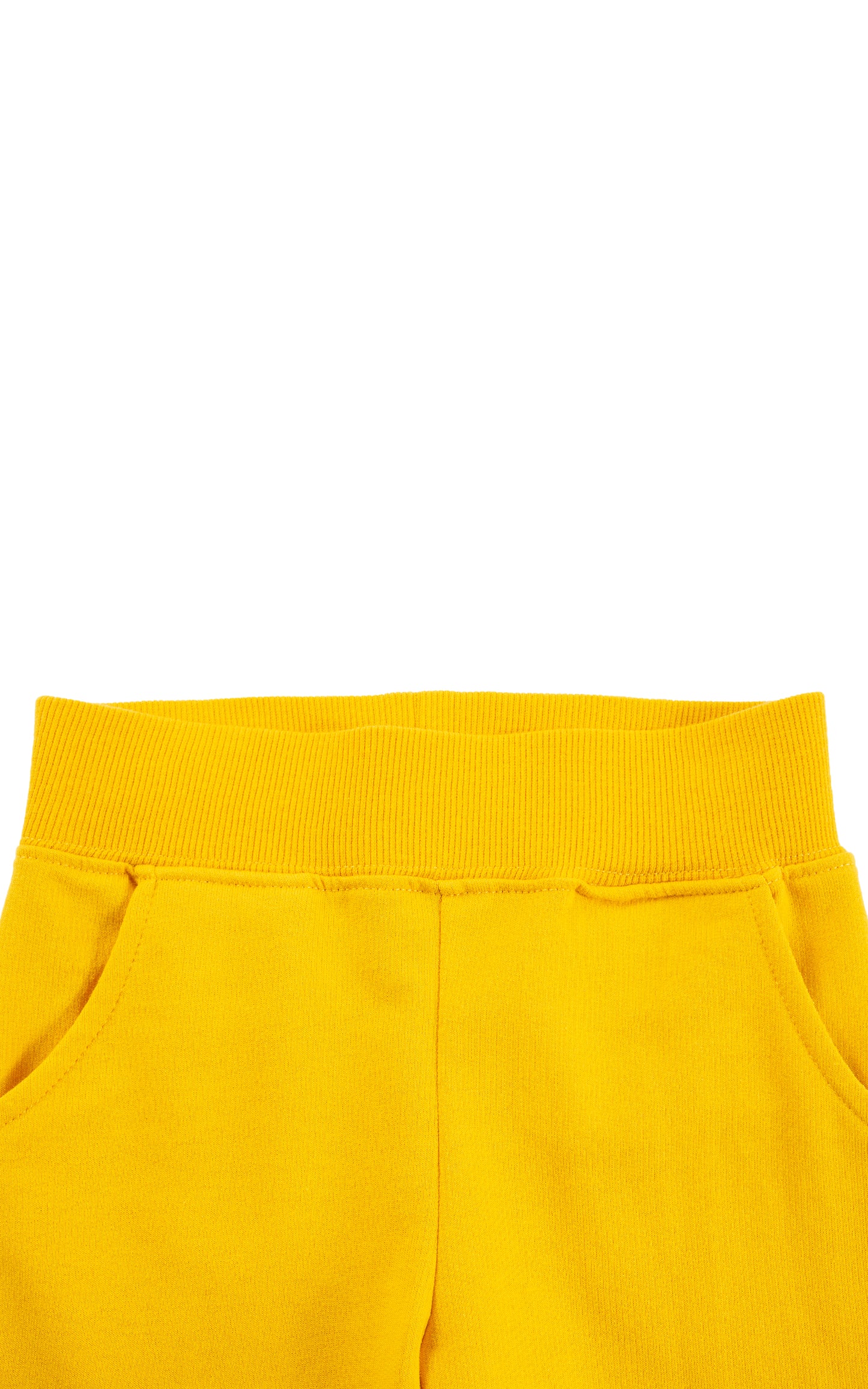 Close up of bright yellow sweatpants with wide elastic ribbed waistband