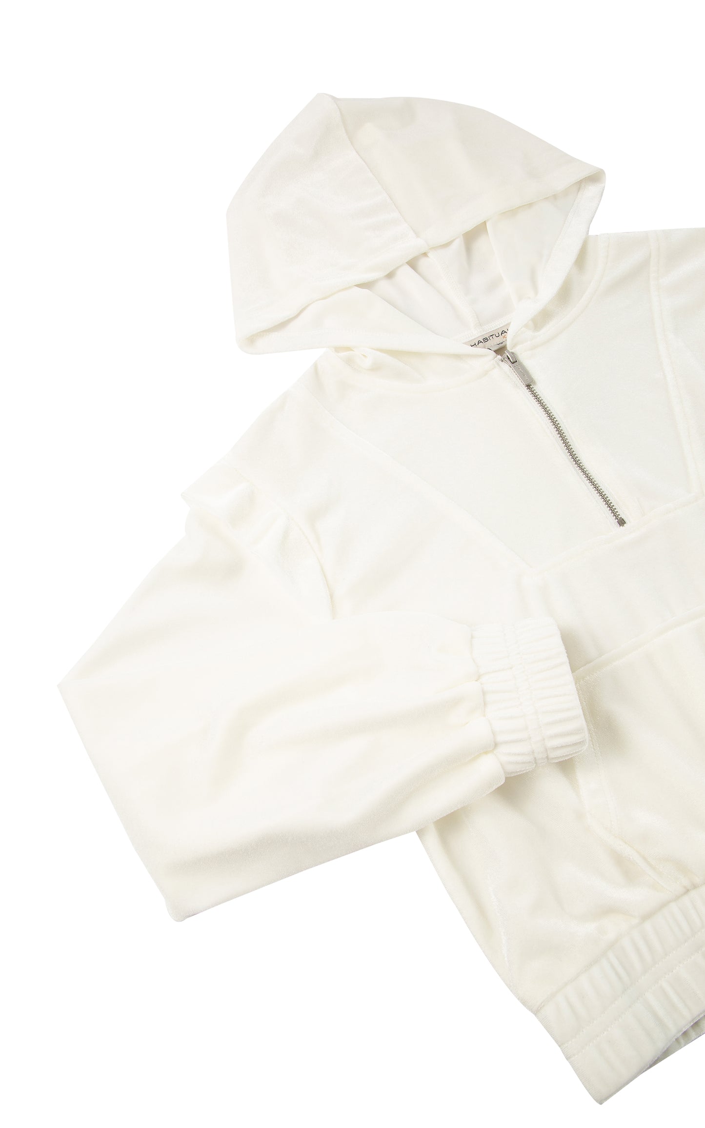 Detail view of a white velour long sleeve hoodie