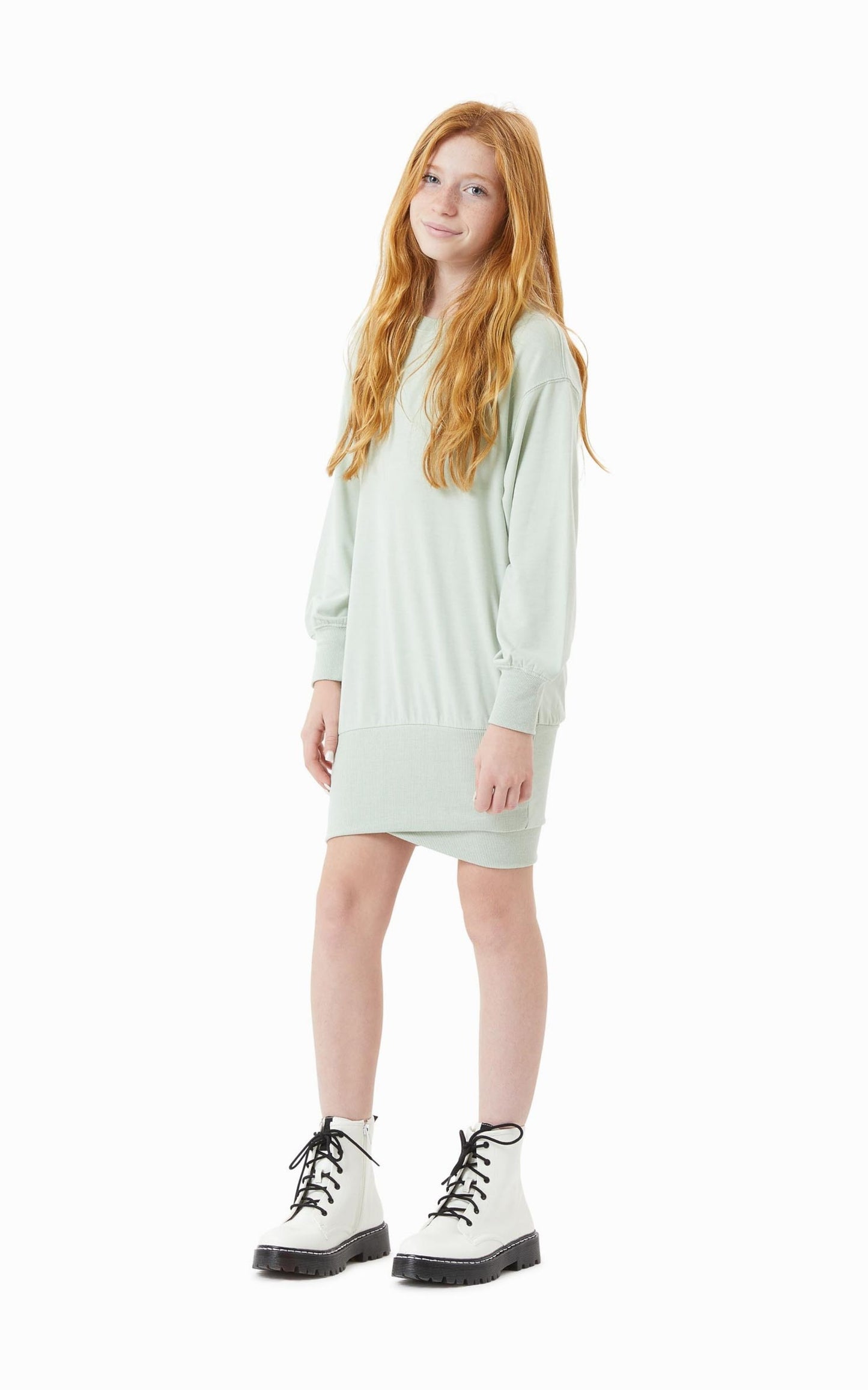 Front view of young girl in a sage green drop waist cotton dress 
