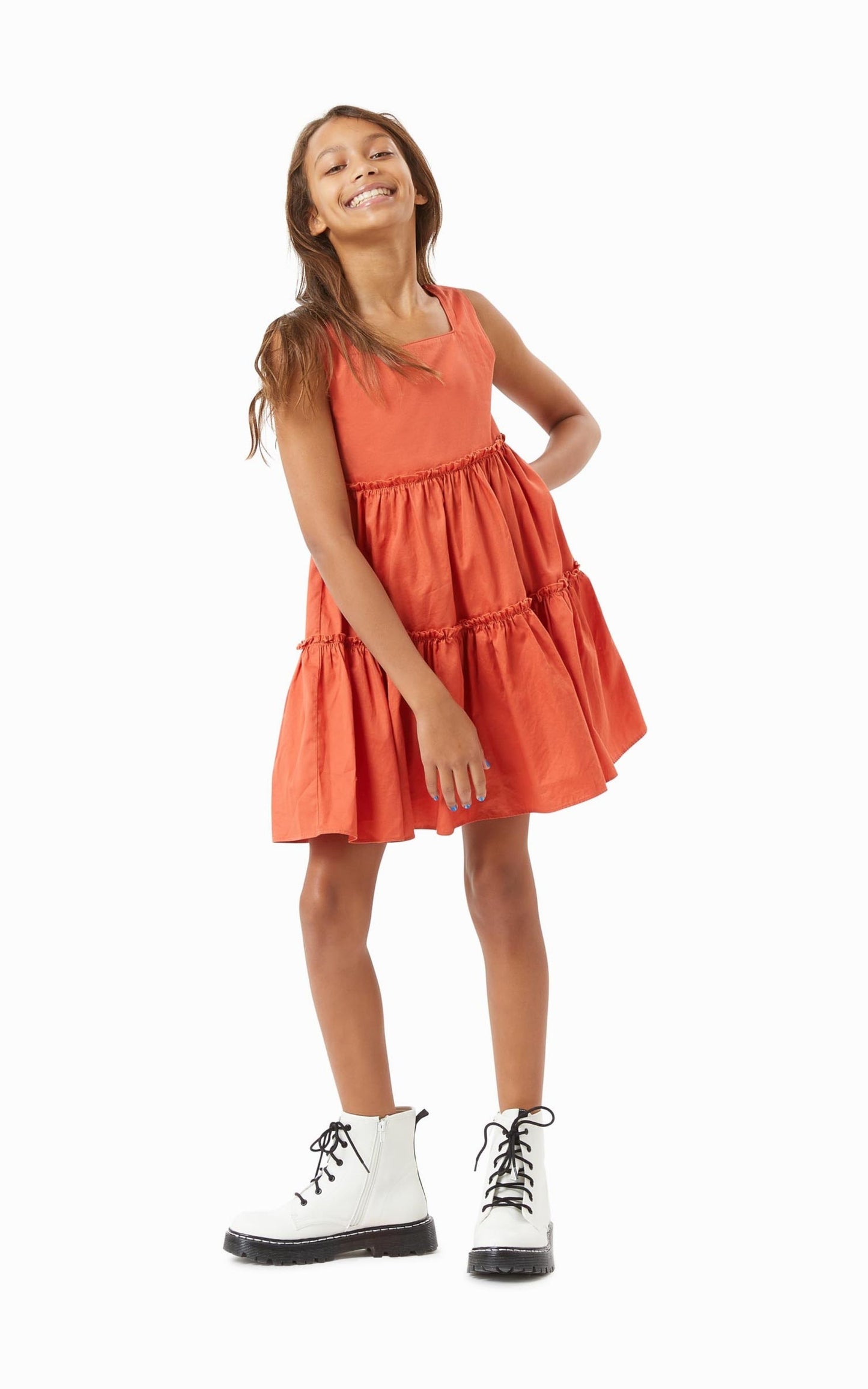 Girl in motion wearing rust tiered baby doll dress