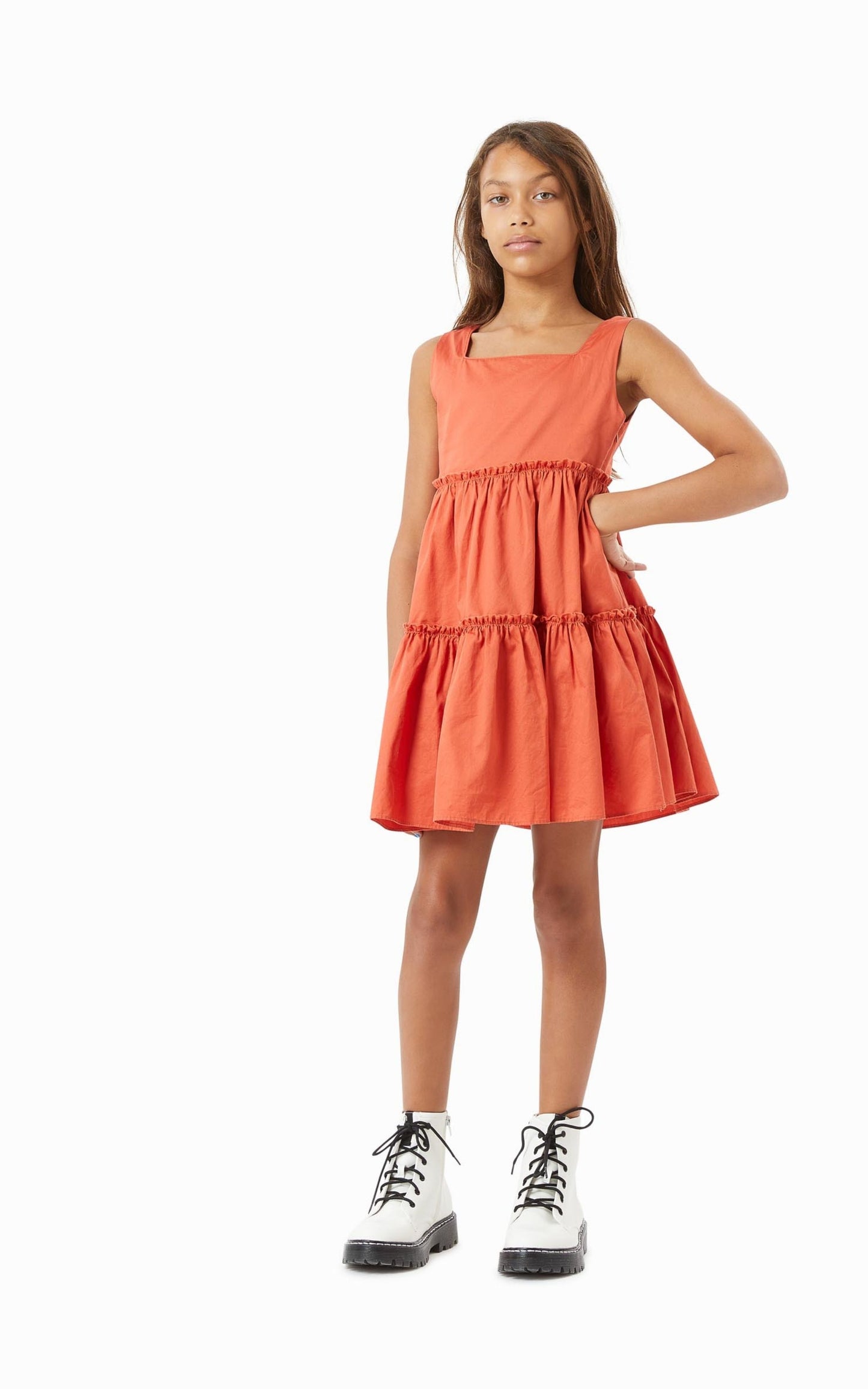 Girl wearing rust tiered baby doll dress