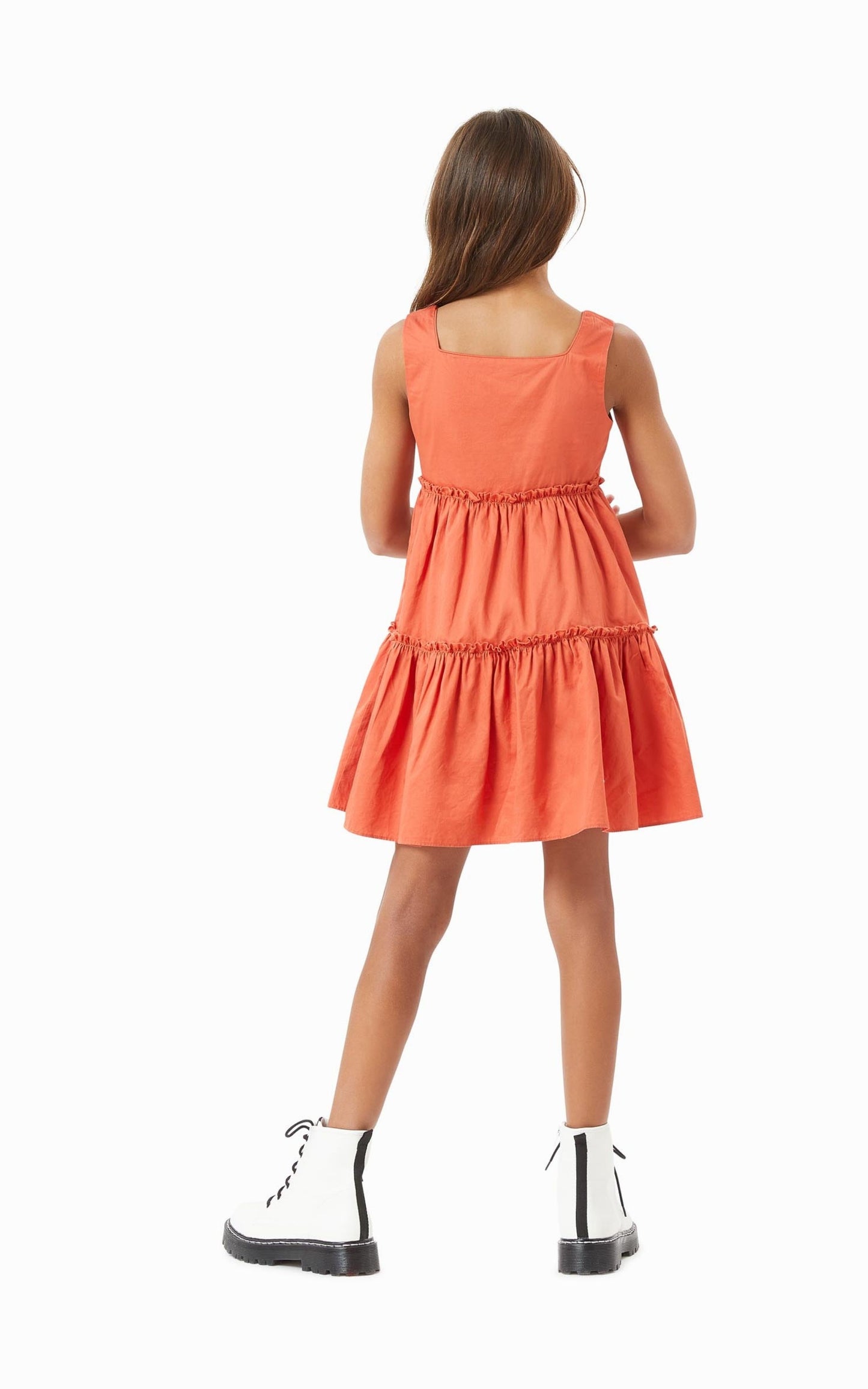 Back of girl wearing rust tiered baby doll dress