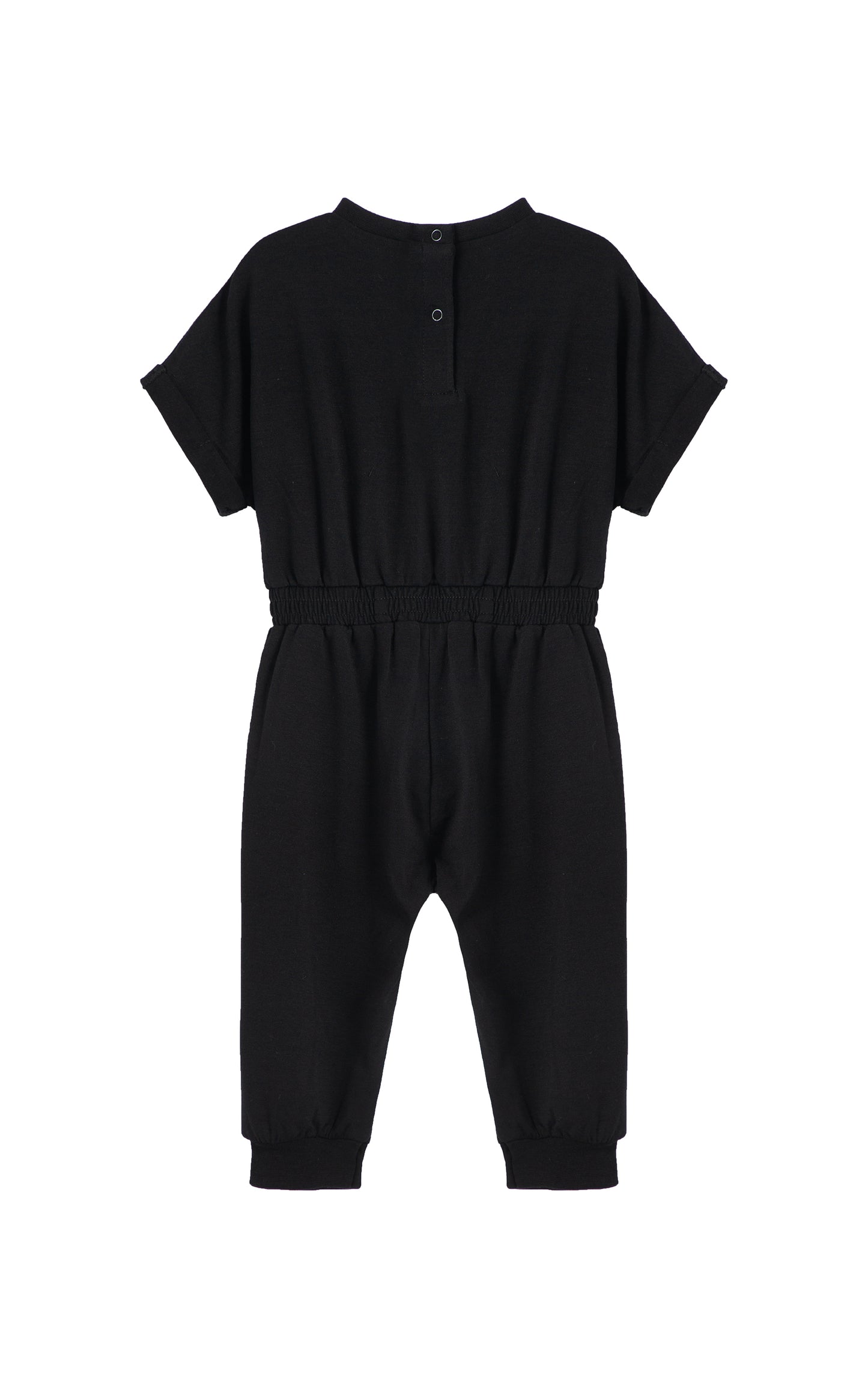 Back view of black romper with folded cuff sleeves.