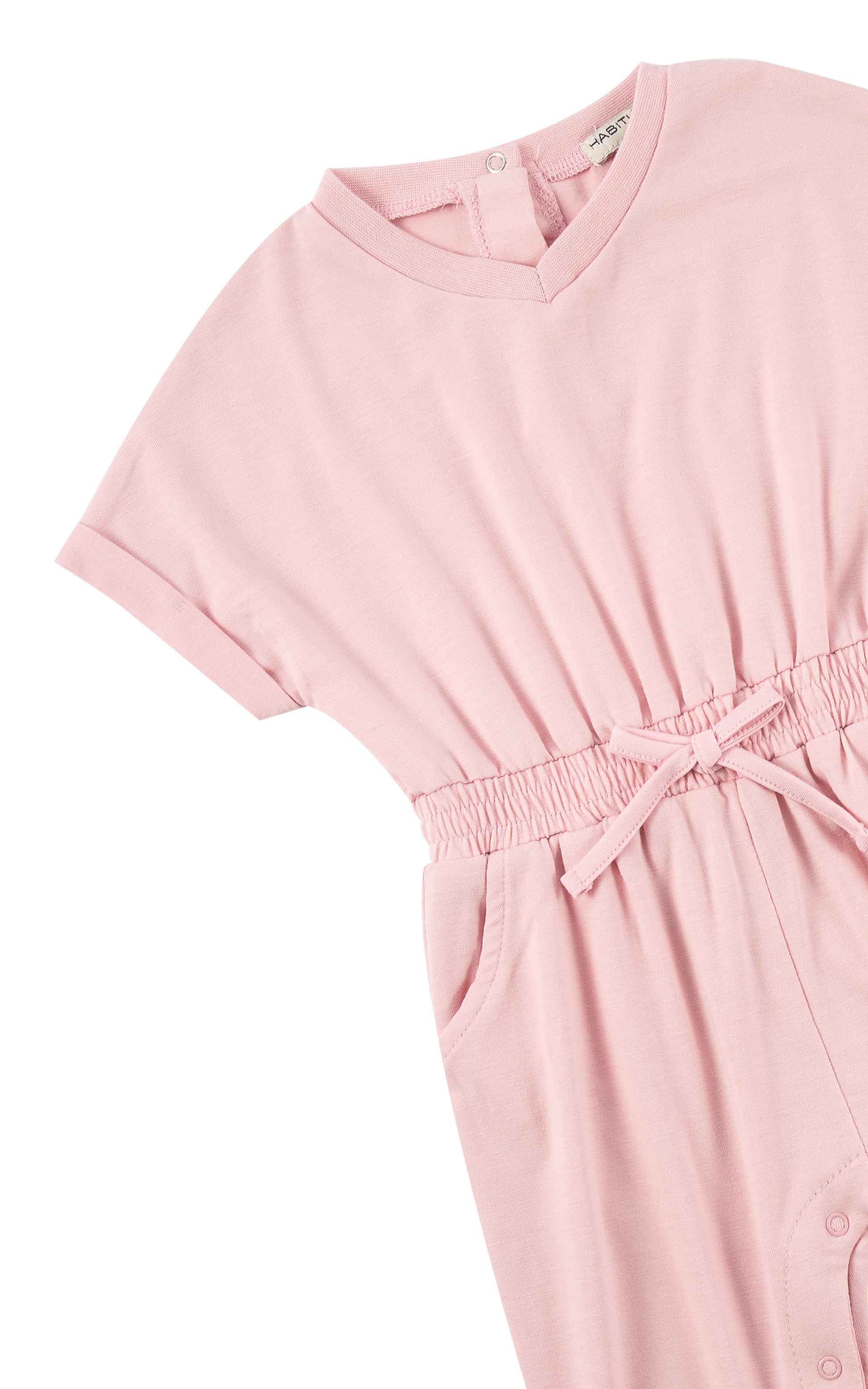 Close up of sleeve and tie waist on pink romper with folded cuff.