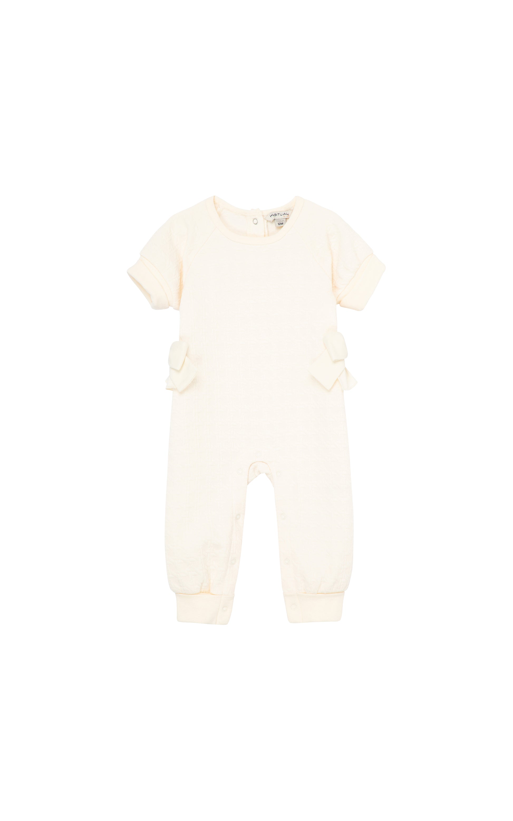 Off-white double knit coverall with cuffed short sleeves, cuffed ankles, and medium-sized bows on sides 