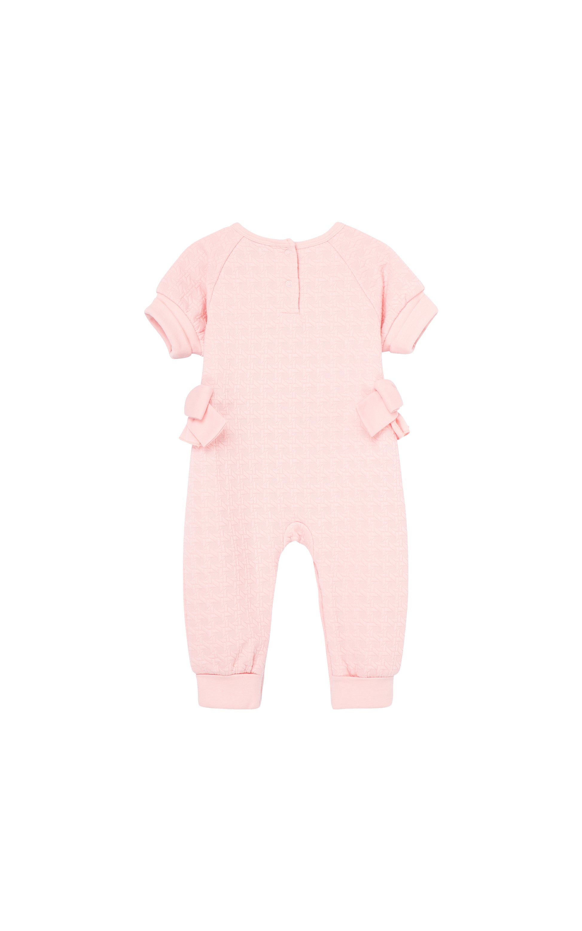 Back view of pink coverall with cuffed short sleeves and ankles, two snap back closure, and bows on both sides