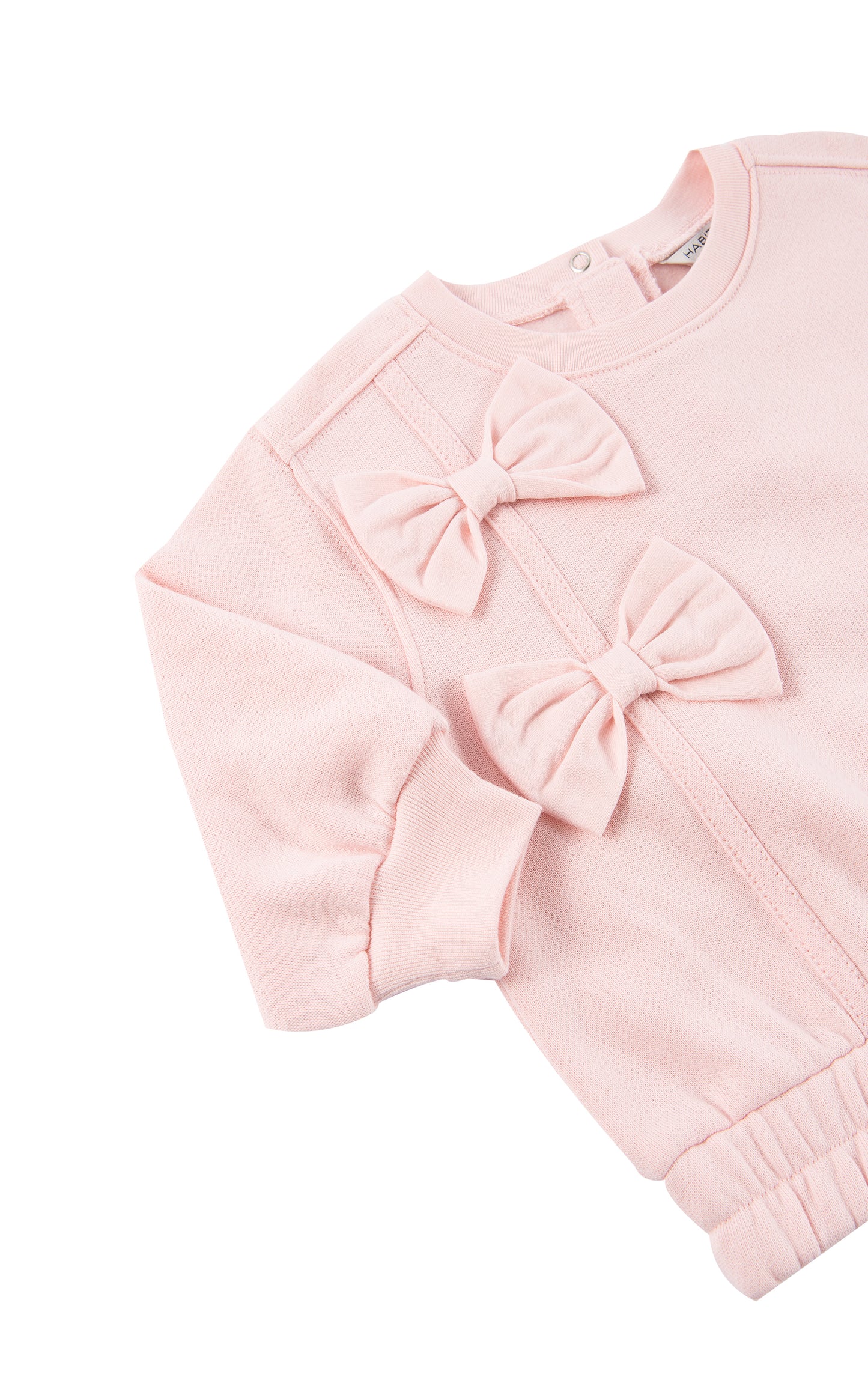Side view of pink fleece sweatshirt with a bow 