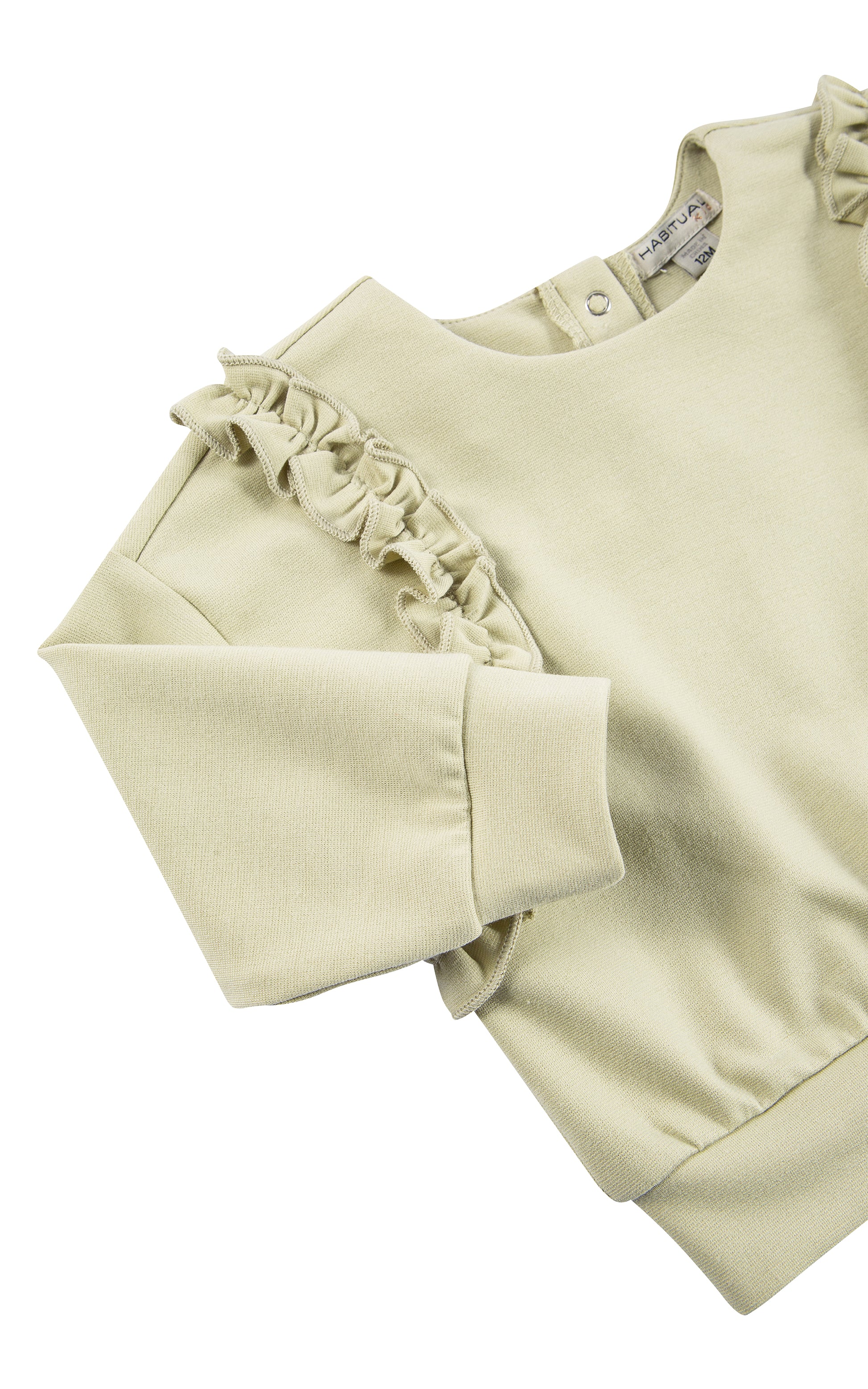 Close up view of top of olive ruched knit set with ruffles stitched from shoulder to mid-waist